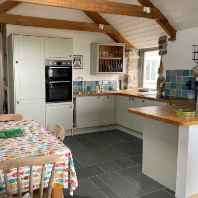 Photo of open plan kitchen and dining room table at Trengothal Barn holiday let in Cornwall
